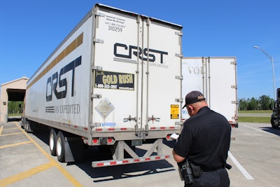 truck inspector looking at rear of trailer