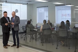 employees discussing technology in corporate setting
