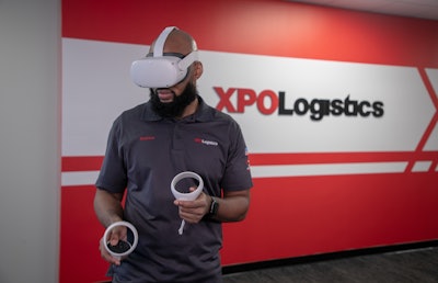 An XPO Logistics trainee using the Oculus for Business headset and handheld controllers