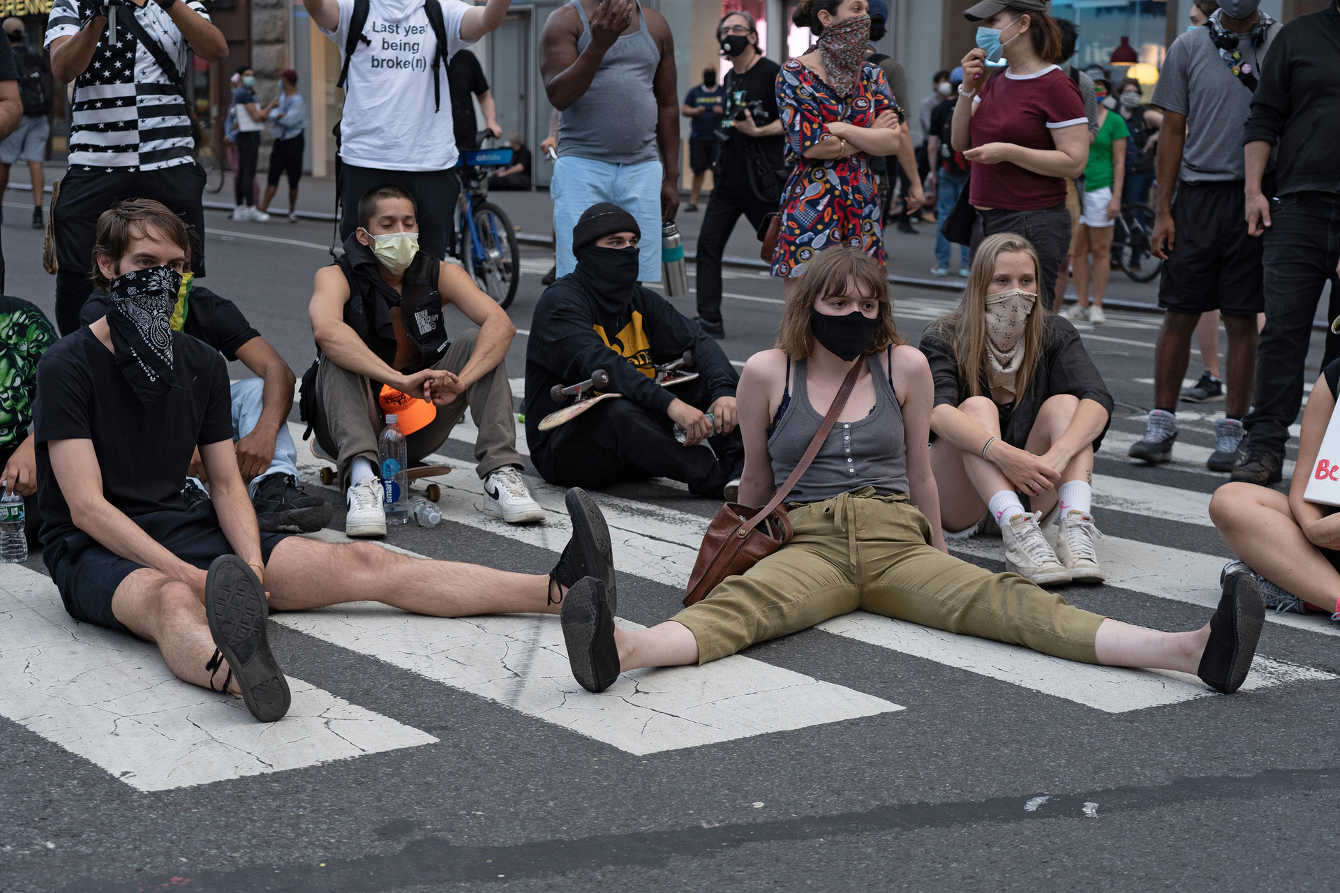Protestors sitting in a crosswalk and blocking traffic on May 30, 2020