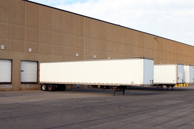 Semi-truck trailers parked at a warehouse