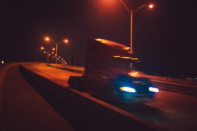 class 8 truck on the highway at night