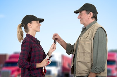 A man handing a set of keys to a female