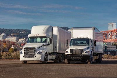 Two white semi trucks parked next to each other