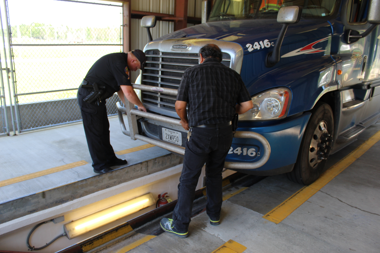 Men inspecting semi truck