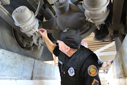 Man inspecting semi truck