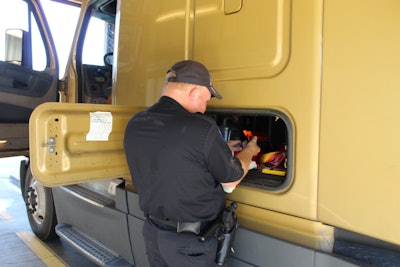 Man inspecting semi truck