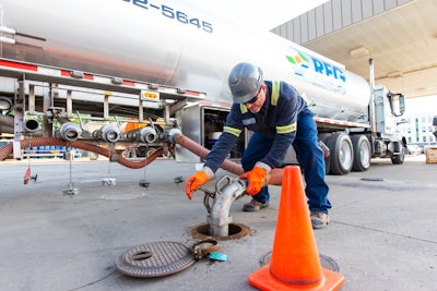 man adding fuel to truck