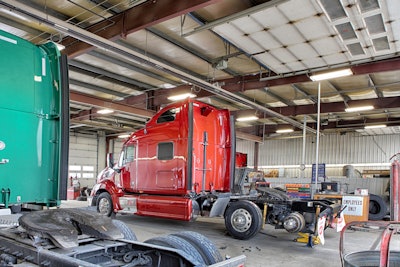 Semi-trucks receiving maintenance work in a garage