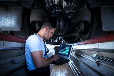 man looking at analytics on laptop