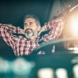 Man sitting in driver seat of truck