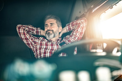 Man sitting in driver seat of truck