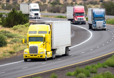 4 semi trucks on highway