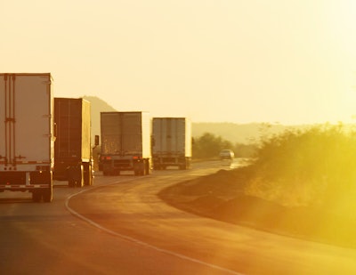 Semi trucks driving along highway