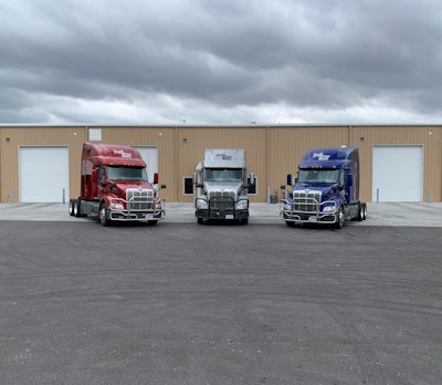 3 trucks backed up into in loading dock area