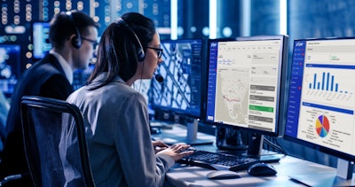 women and man on headsets sitting at desks on desktops