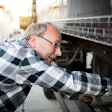 man performing truck maintenance inspection