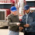trucks talking outside of semi trucks