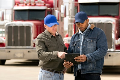 trucks talking outside of semi trucks