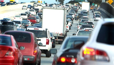 Trucks and cars in traffic.