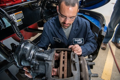 Bendix technician working on air disc brakes