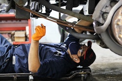 a mechanic conducting an oil change