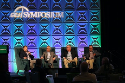 four men sitting in chairs on stage at the 2021 ccj symposium