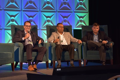 John Thomas, left, and Cedric Daniels, middle, discuss the future of fueling trucks with CCJ Editor Jason Cannon.