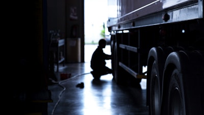 Technician working on truck tire
