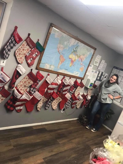 Silver Creek office with Christmas stockings hanging on a wall around a world map
