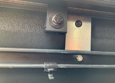 Adapter brackets included the BakFlip MX4 kit allow the original Toyota Tundra accessory rail (shown at the bottom) to remain for use.