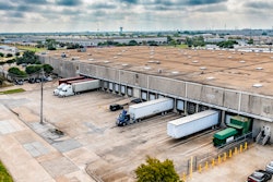 trucks and trailers being loaded at a warehouse