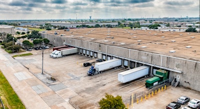 trucks and trailers being loaded at a warehouse