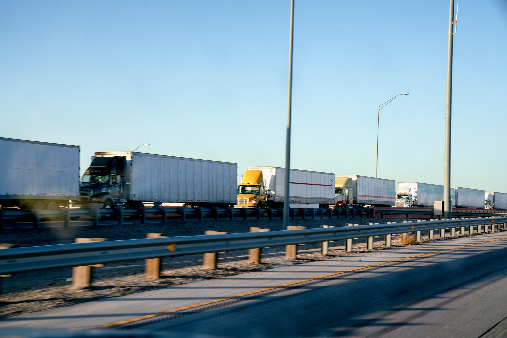 line of semi trucks in traffic