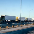 line of semi trucks in traffic