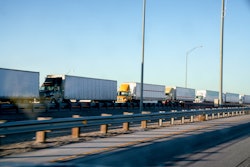 line of semi trucks in traffic