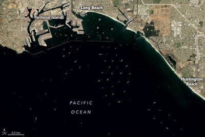 A satellite image of container ships in the pacific ocean along California's coast