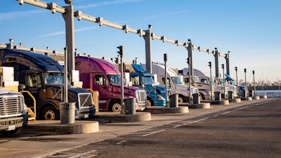 Trucks waiting at Port of Los Angeles new container fees