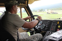 A soldier in the National Guard drives a truck