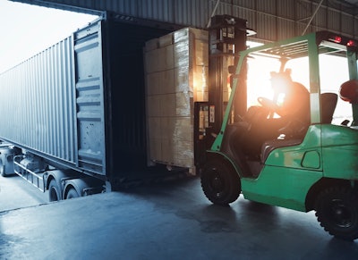 forklift loading a trailer