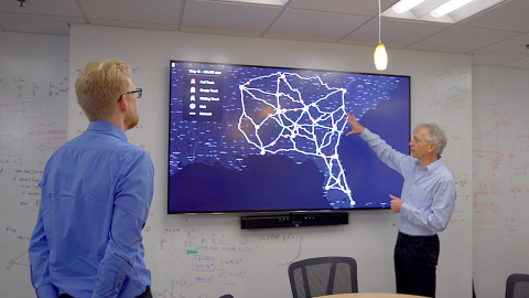 Professor Pascal Van Hentenryck and student looking at a map on a screen