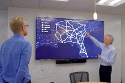 Professor Pascal Van Hentenryck and student looking at a map on a screen