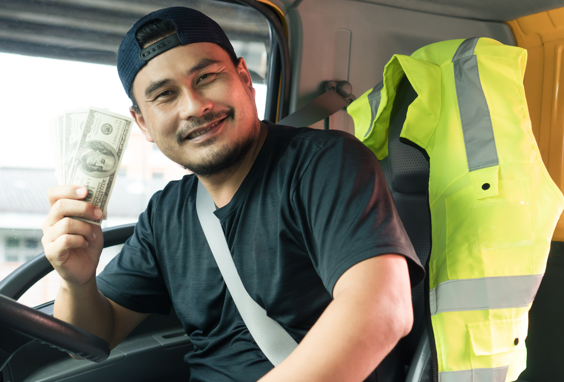 truck driver holding cash after getting paid