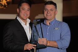 Tim Tran, vice president of systems and technology for JLE Industries, accepts the Innovator of the Year Award from CCJ Editor Jason Cannon.