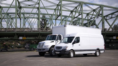 Two leasing trucks parked in a lot