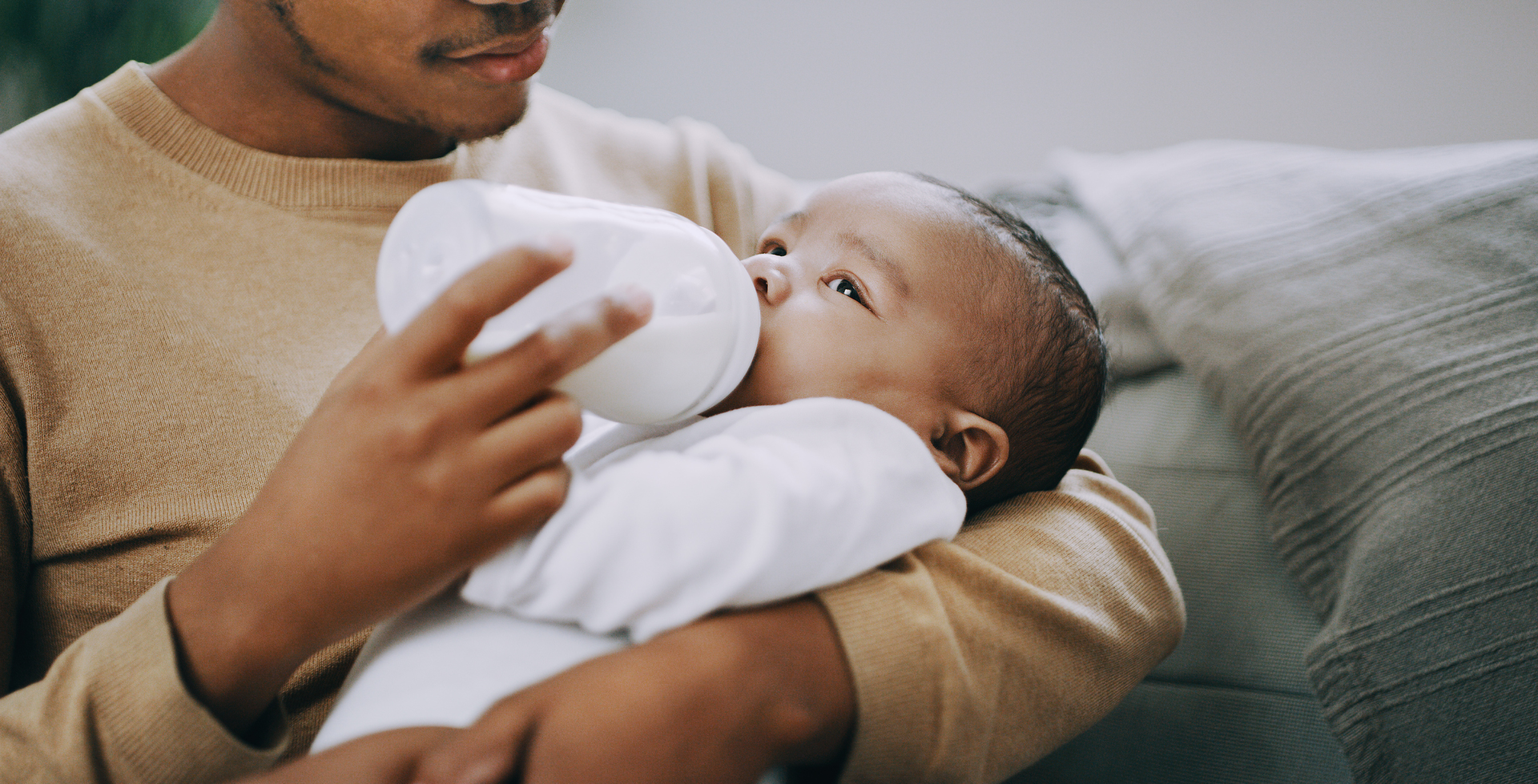 man feeding a baby