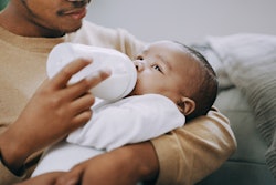 man feeding a baby