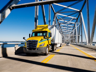 Penske semi-truck crossing a bridge