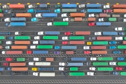 aerial shot of semi-trucks hauling containers