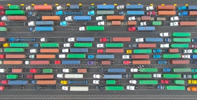aerial shot of semi-trucks hauling containers